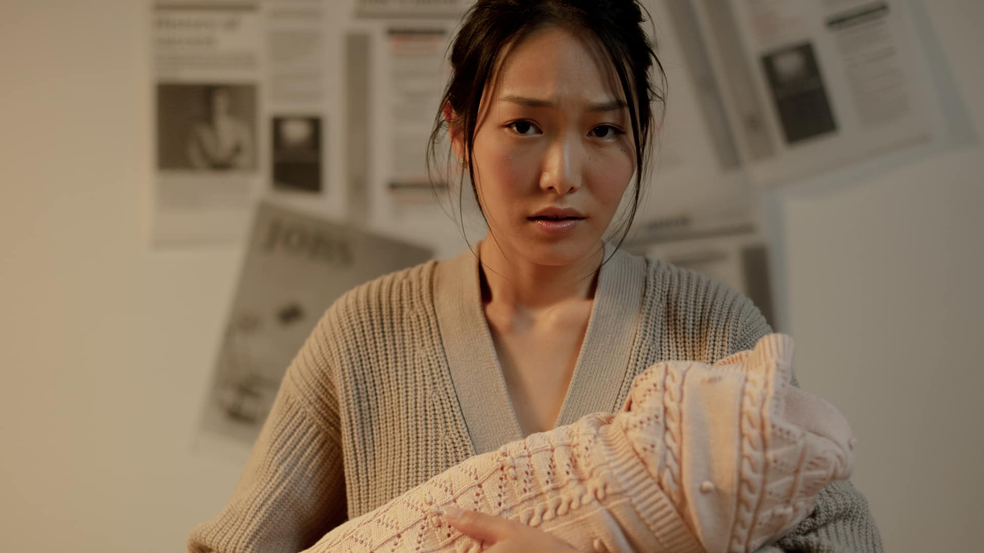 Worried woman holding baby close