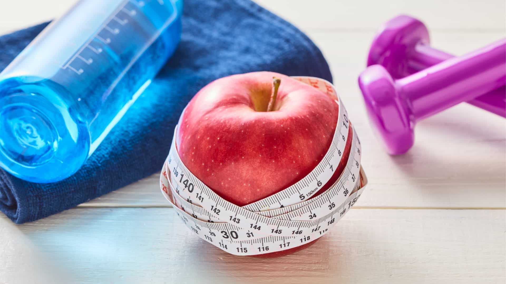 Apple with tape measure and weights