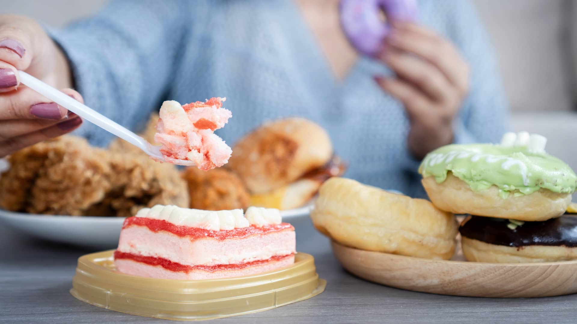Person eating sweets and fried food