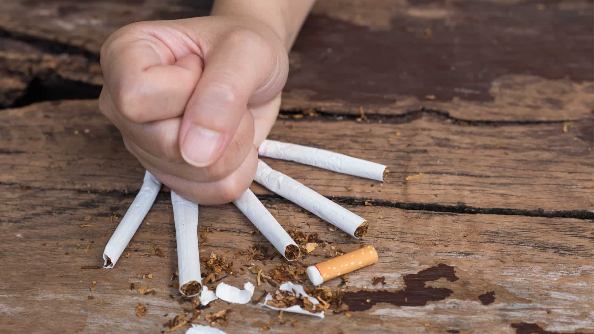 Fist crushing cigarettes