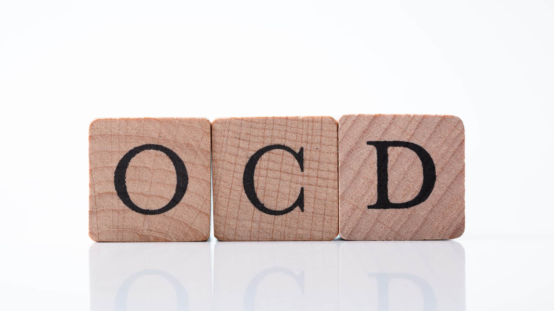 Wooden blocks spell out "OCD,"