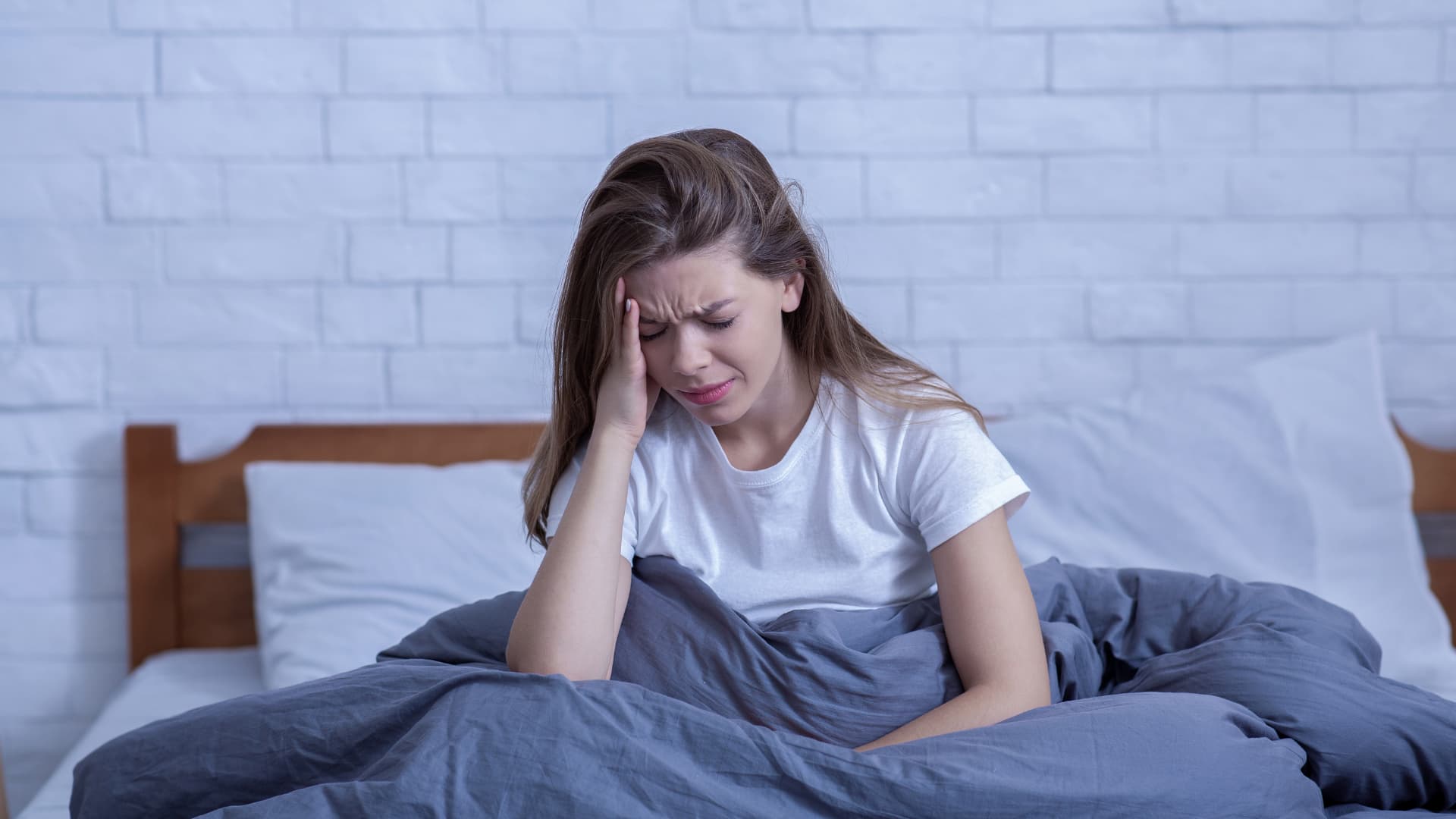 Woman waking up with headache