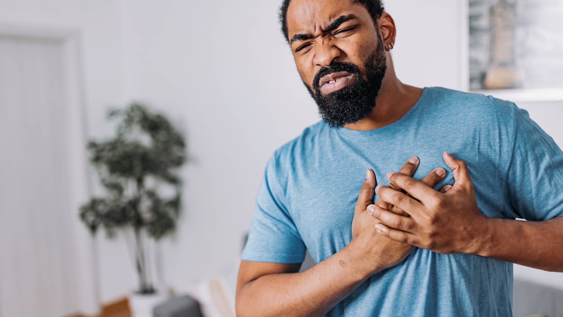 Man clutching chest
