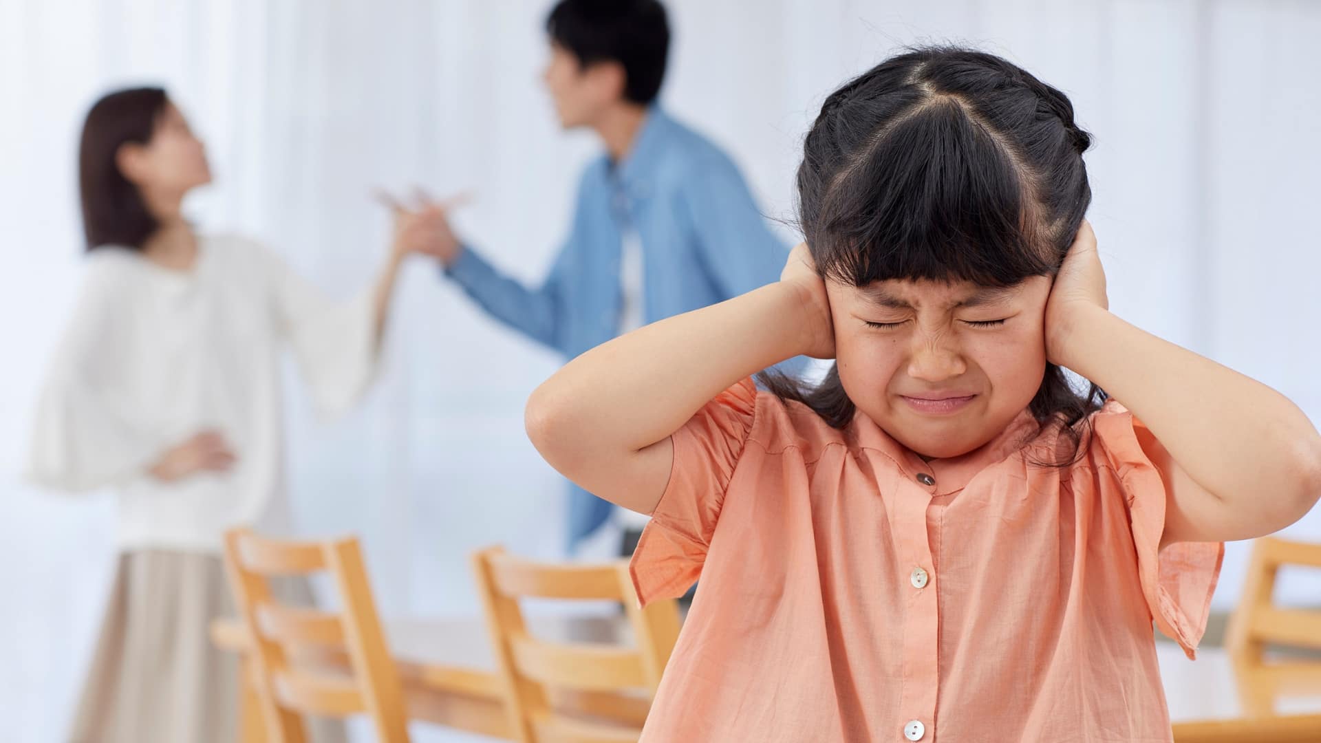 Child covering ears during argument