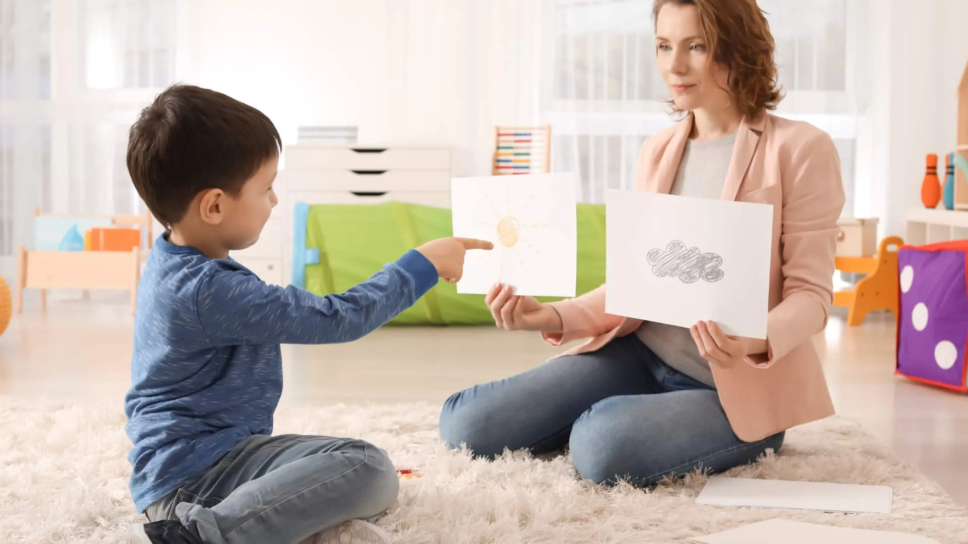 A woman showing a child drawings