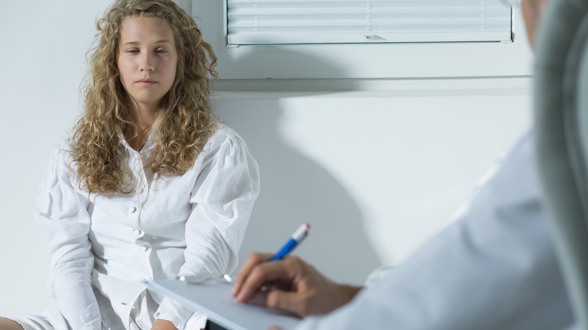 A woman sitting with a clinician
