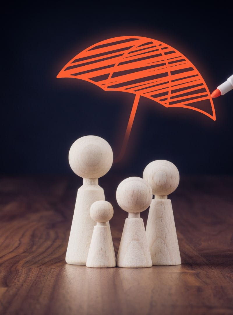 Toy figures under an orange umbrella