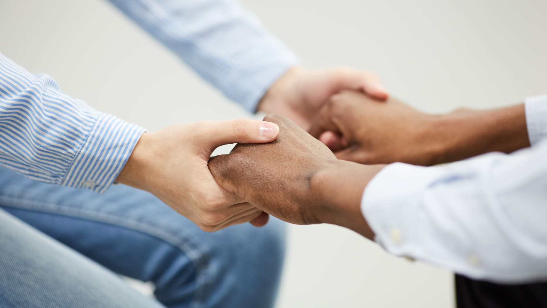 Two people holding hands in a close-up