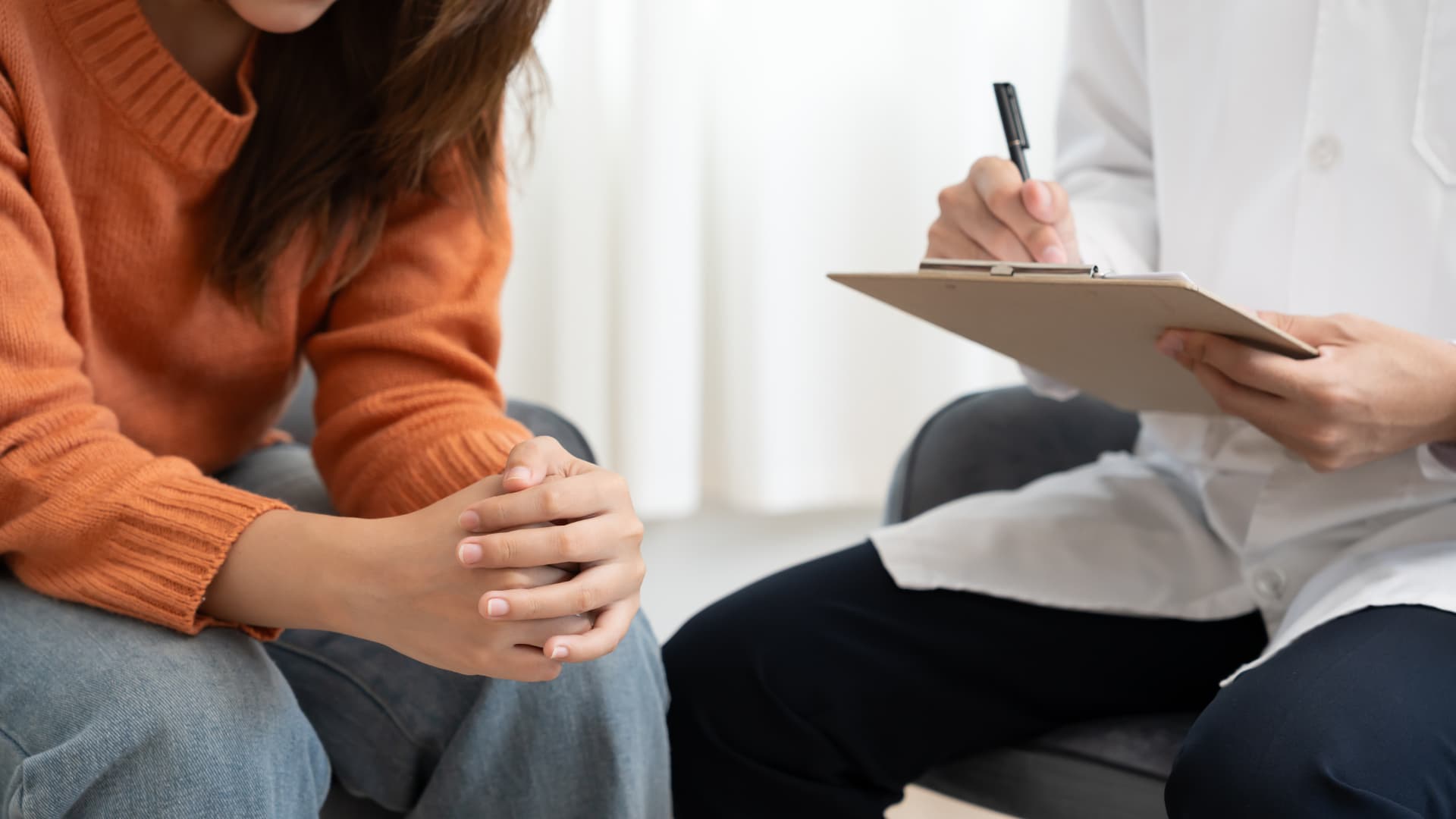 A  therapist listens intently to a client