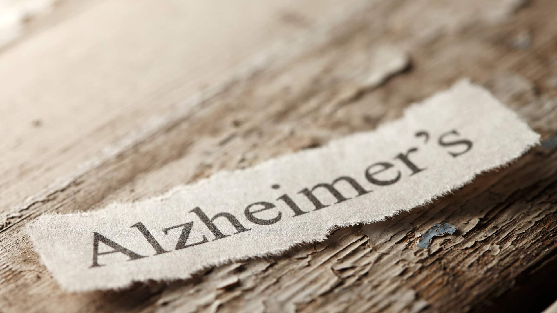 The word "Alzheimer's" on torn paper