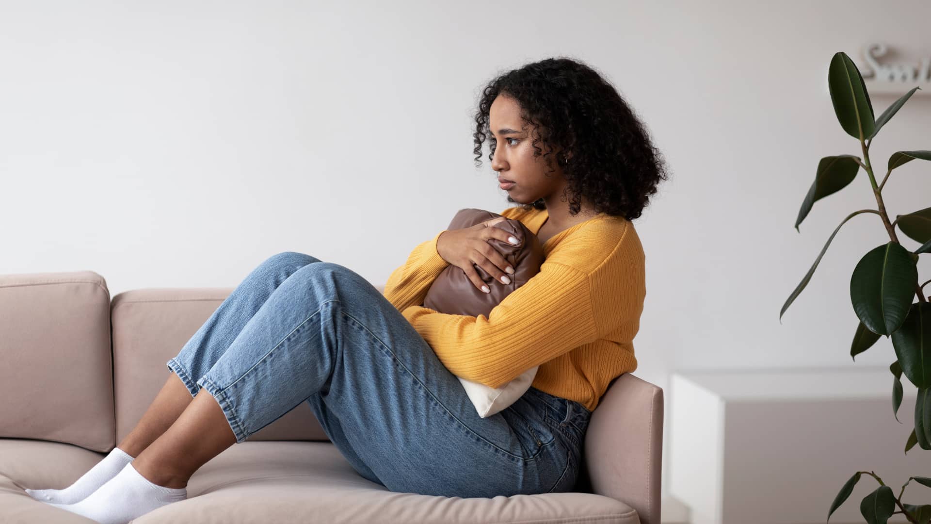 A woman sits alone on a couch