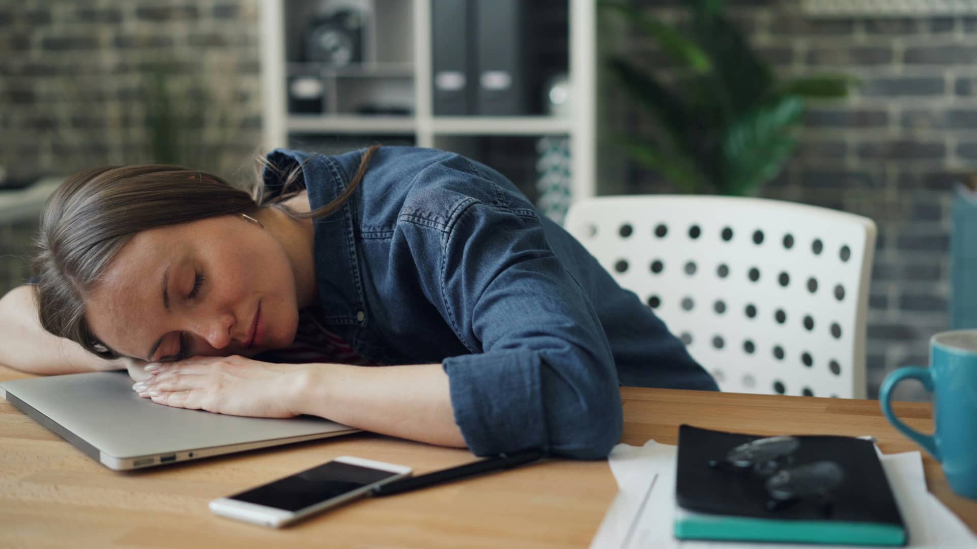 Woman sleeping on her desk