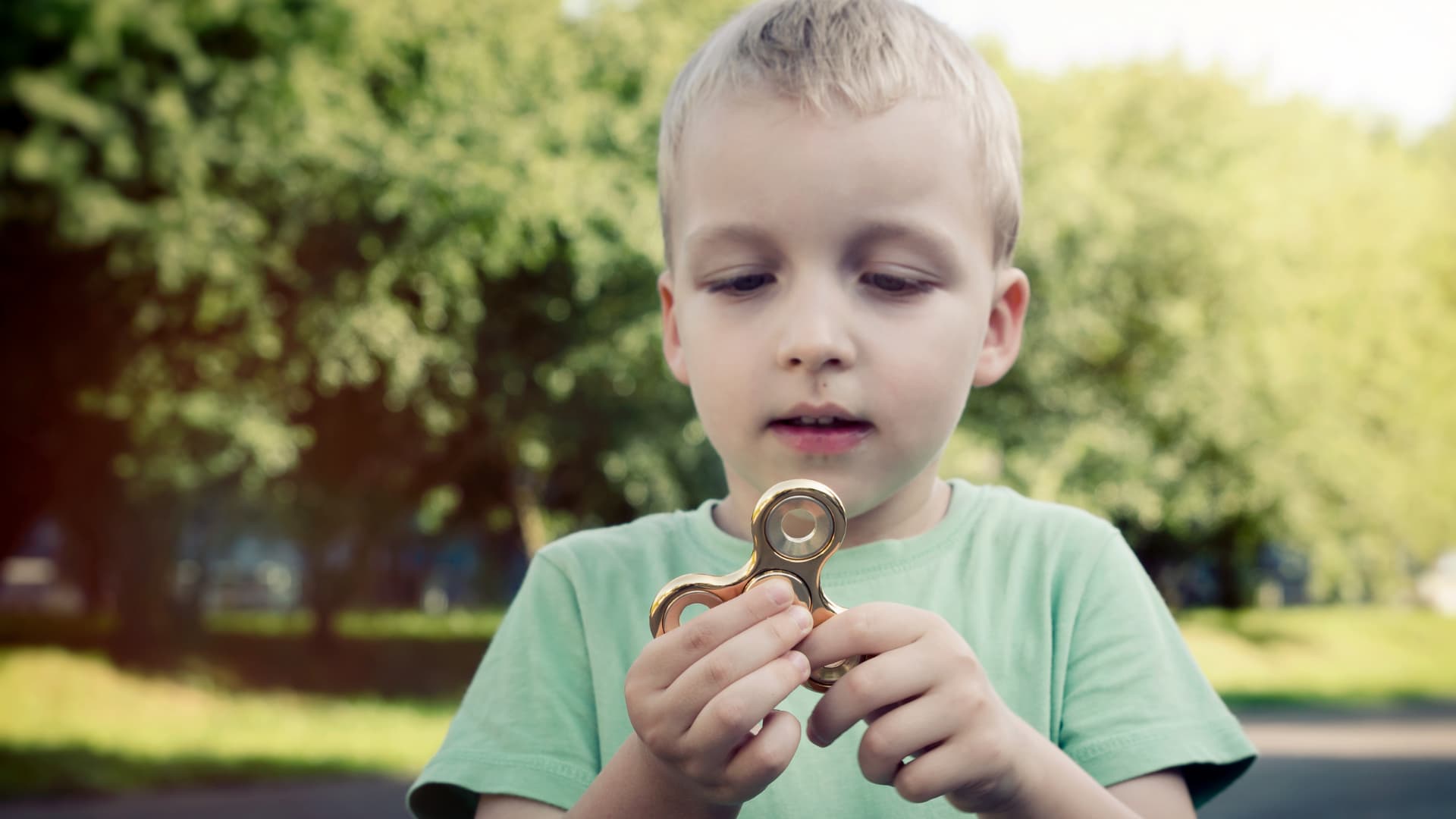 Child playing with a spinner as treatment areas