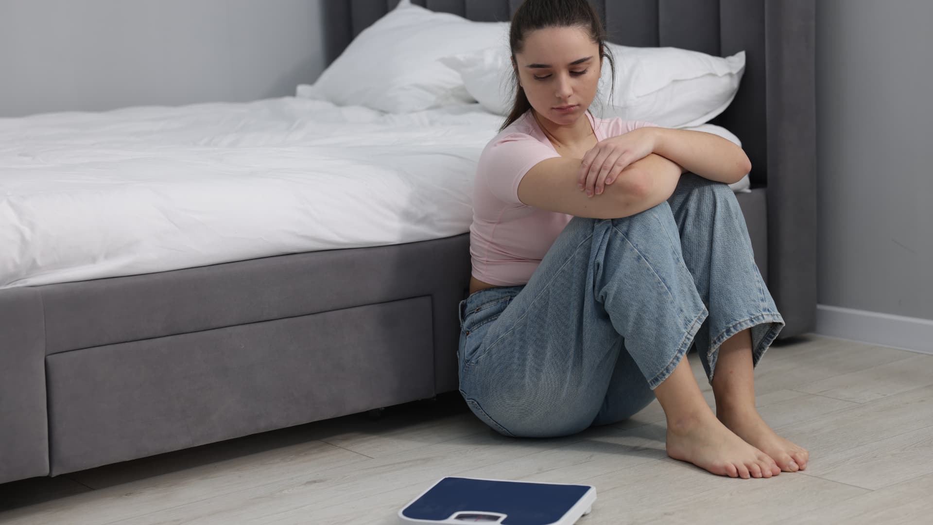 A girl being depressed about her weight indicating to nourish your mind eat well feel good diet and depression