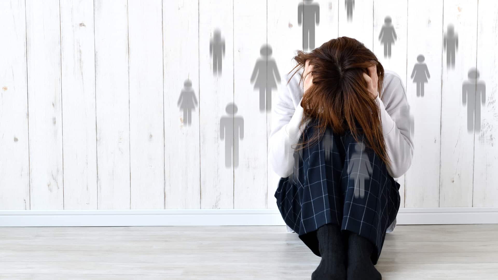 woman sitting on the floor holding her head and more