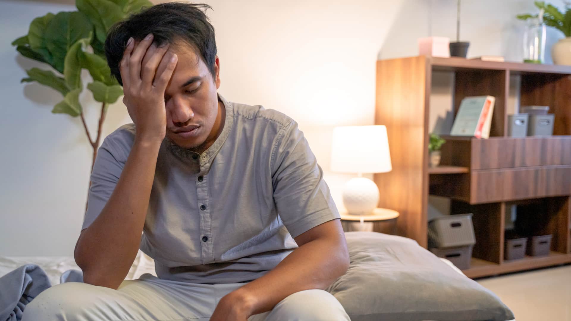 Man sitting in the bed who cannot sleep