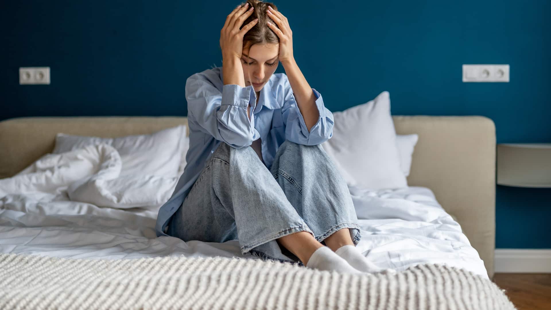girl sitting on the bed gone through trauma and more